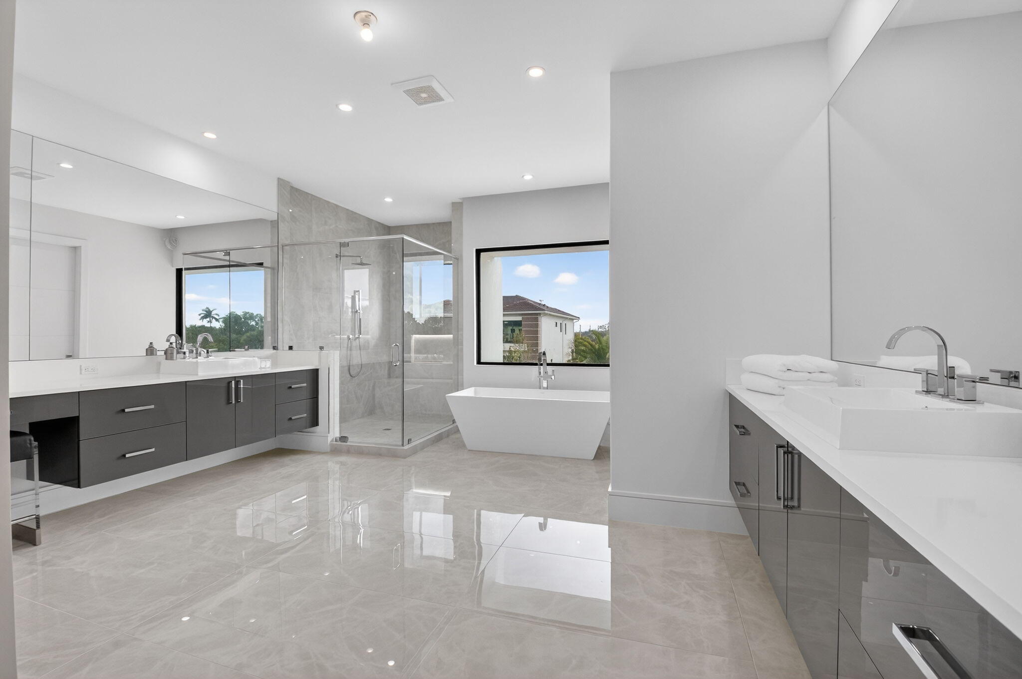 2232 Delray Ridge Lane Delray Beach, FL 33444 - Photo 51 of 68 a bathroom with a double vanity sink a mirror and a bathtub