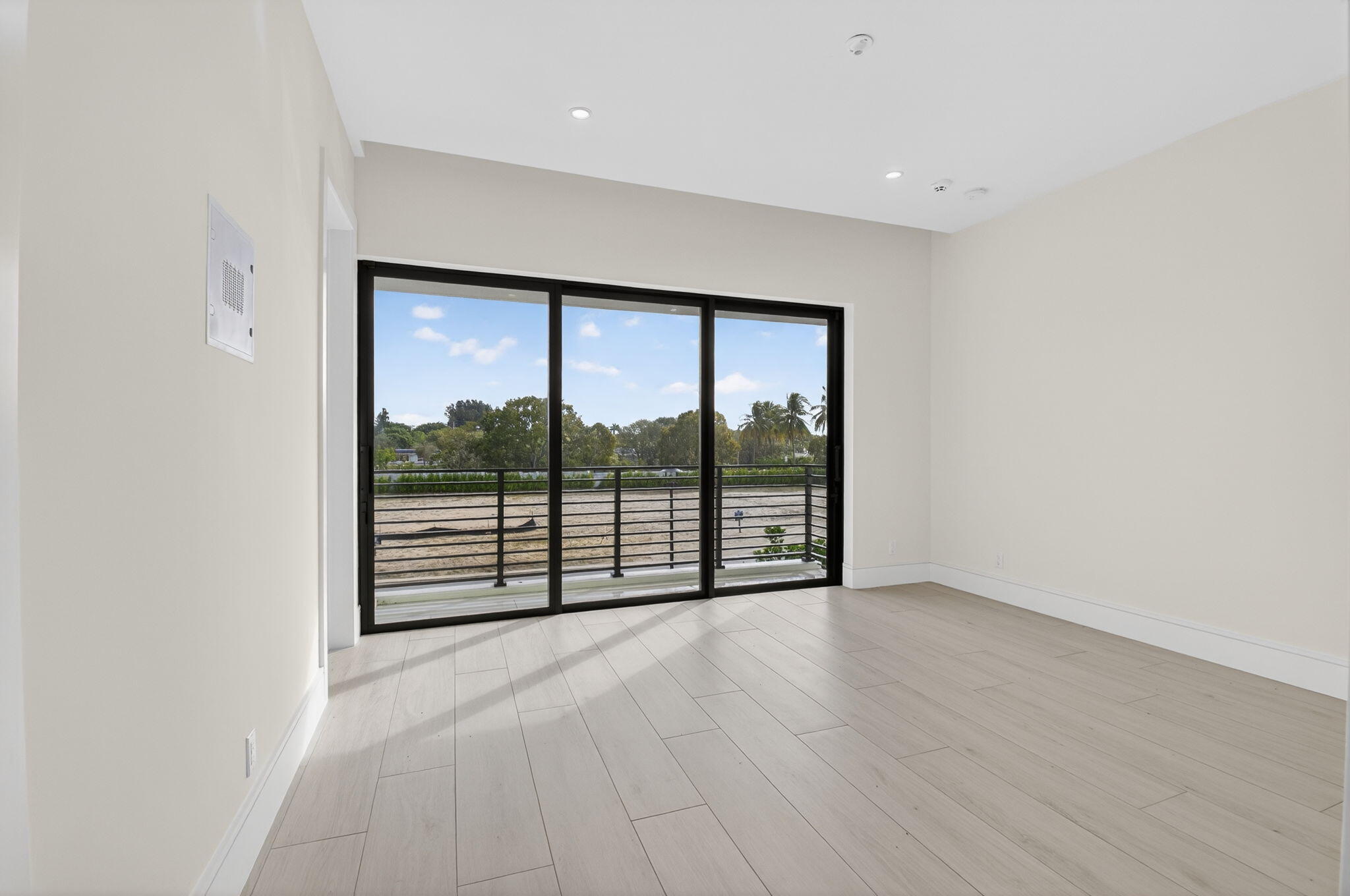 2232 Delray Ridge Lane Delray Beach, FL 33444 - Photo 57 of 68 an empty room with wooden floor and windows