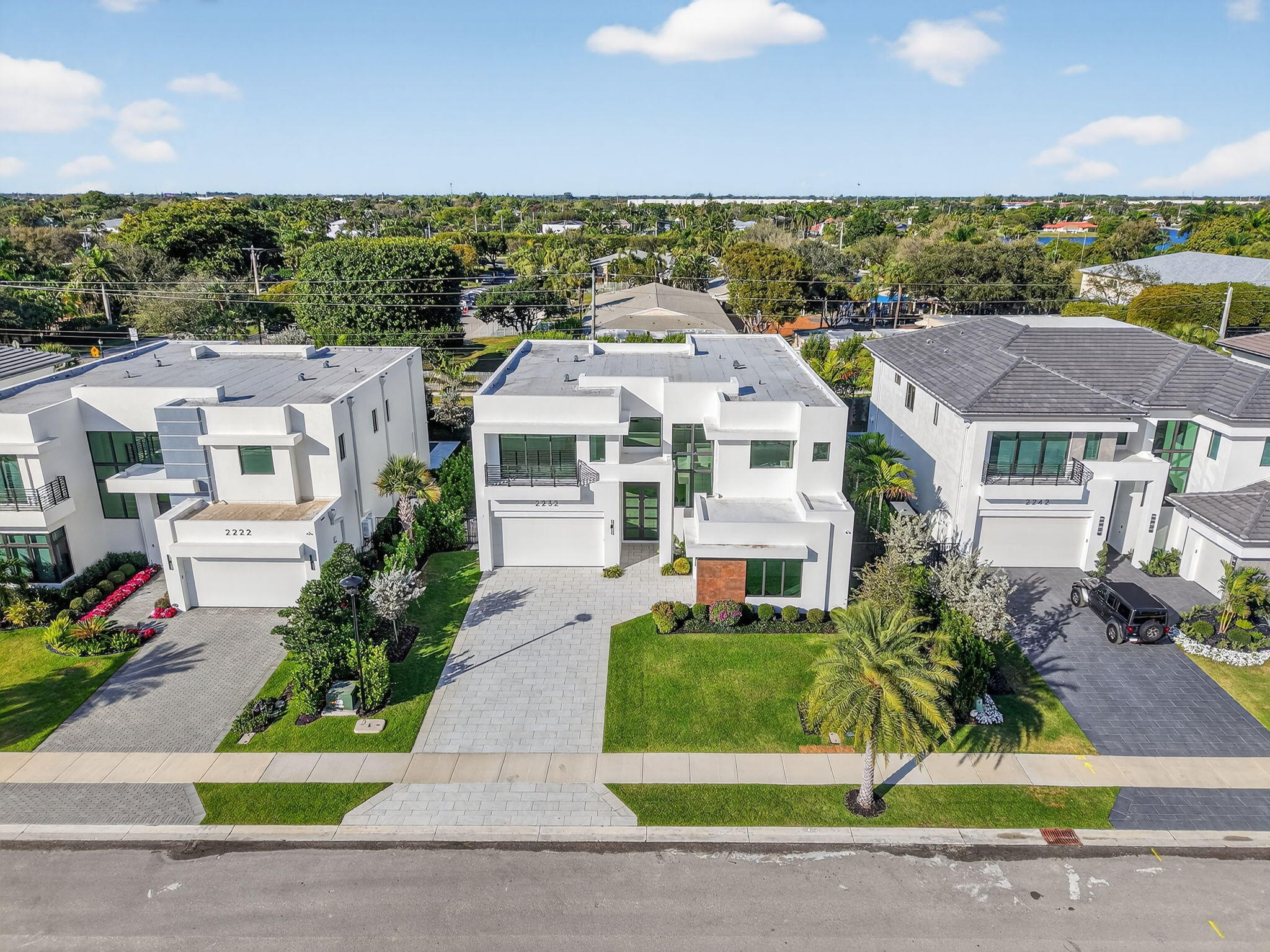 2232 Delray Ridge Lane Delray Beach, FL 33444 - Photo 61 of 68 a front view of a house with a garden and plants