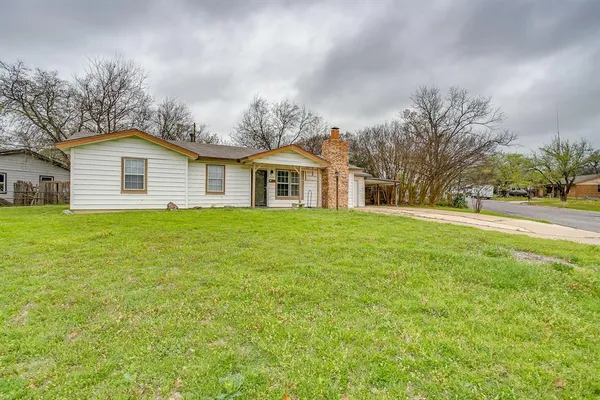a front view of house with yard and green space