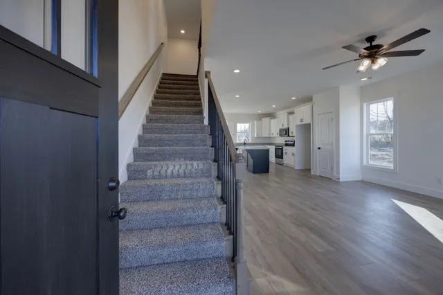 a view of entryway and hall with wooden floor
