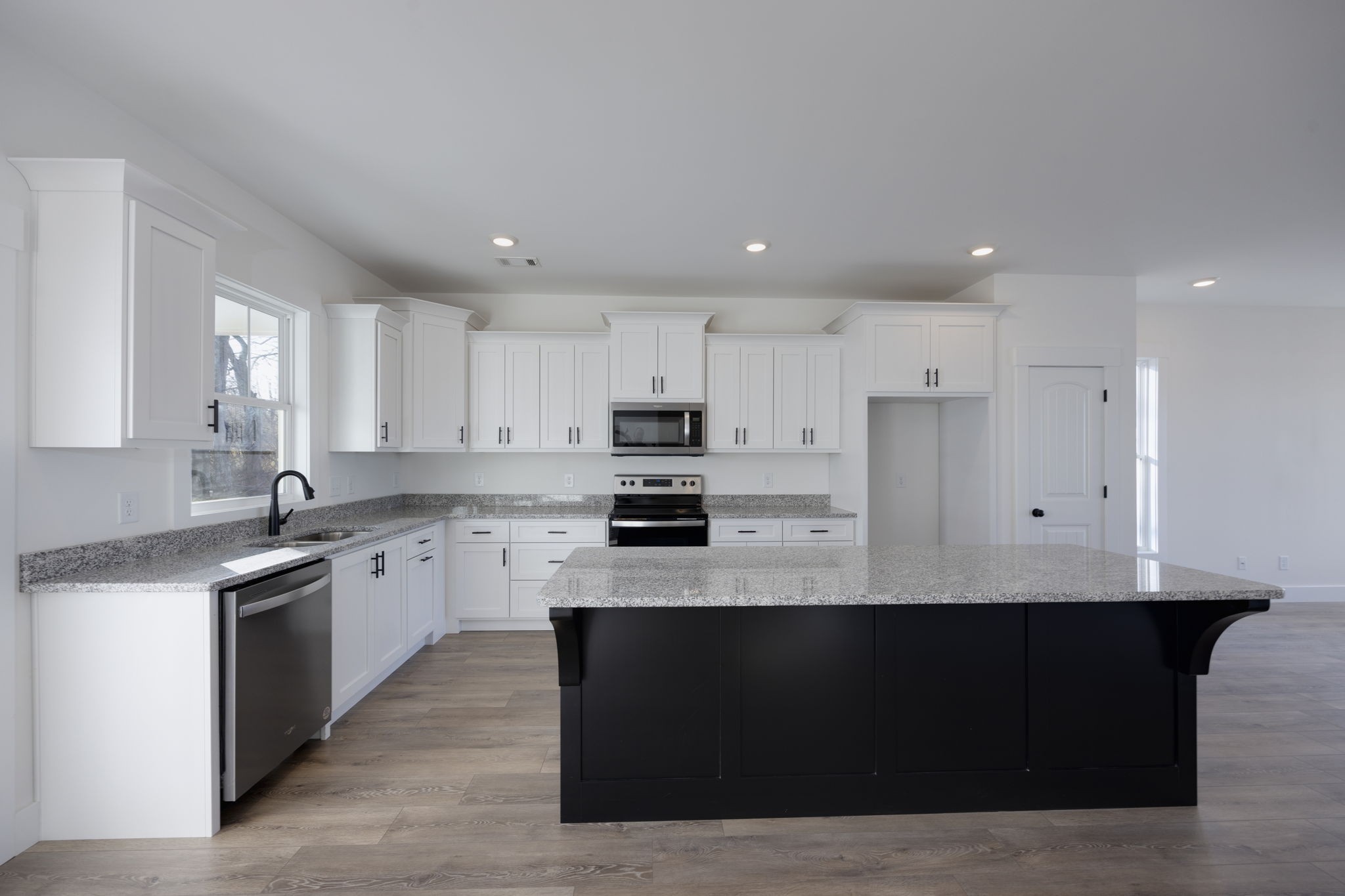 2175 Rylee Way Greenbrier, TN 37073 - Photo 6 of 19 a large kitchen with stainless steel appliances kitchen island granite countertop a stove a sink a refrigerator and white cabinets