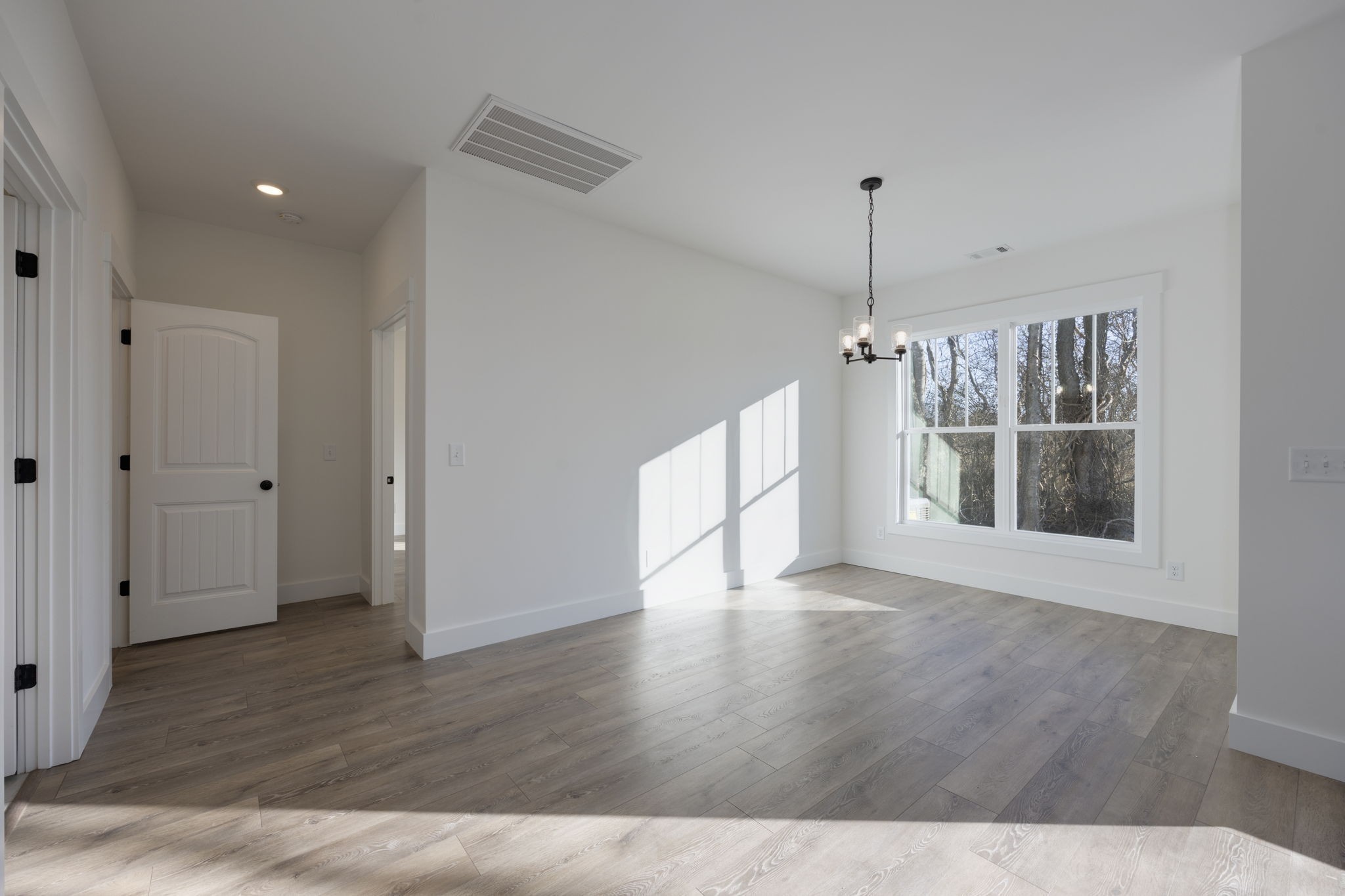 2175 Rylee Way Greenbrier, TN 37073 - Photo 8 of 19 a view of an empty room with wooden floor and a window