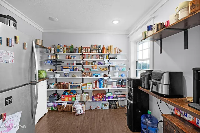 a room with furniture a flat screen tv and a book shelf