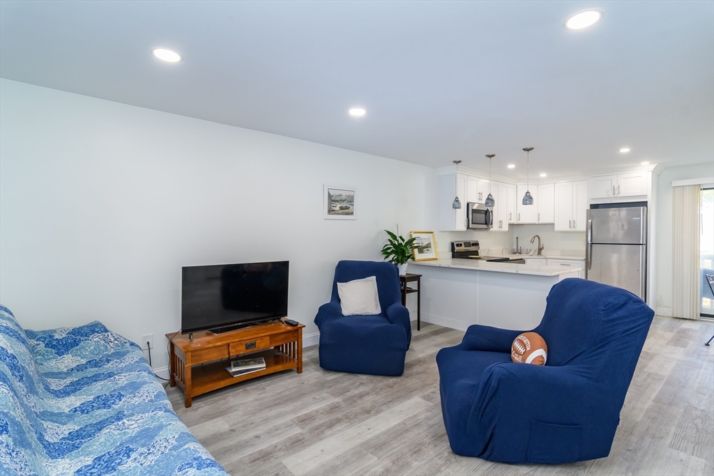 71 Edgeworth Street, Unit 21 Worcester, MA 01605 - Photo 6 of 14 a living room with furniture and a flat screen tv