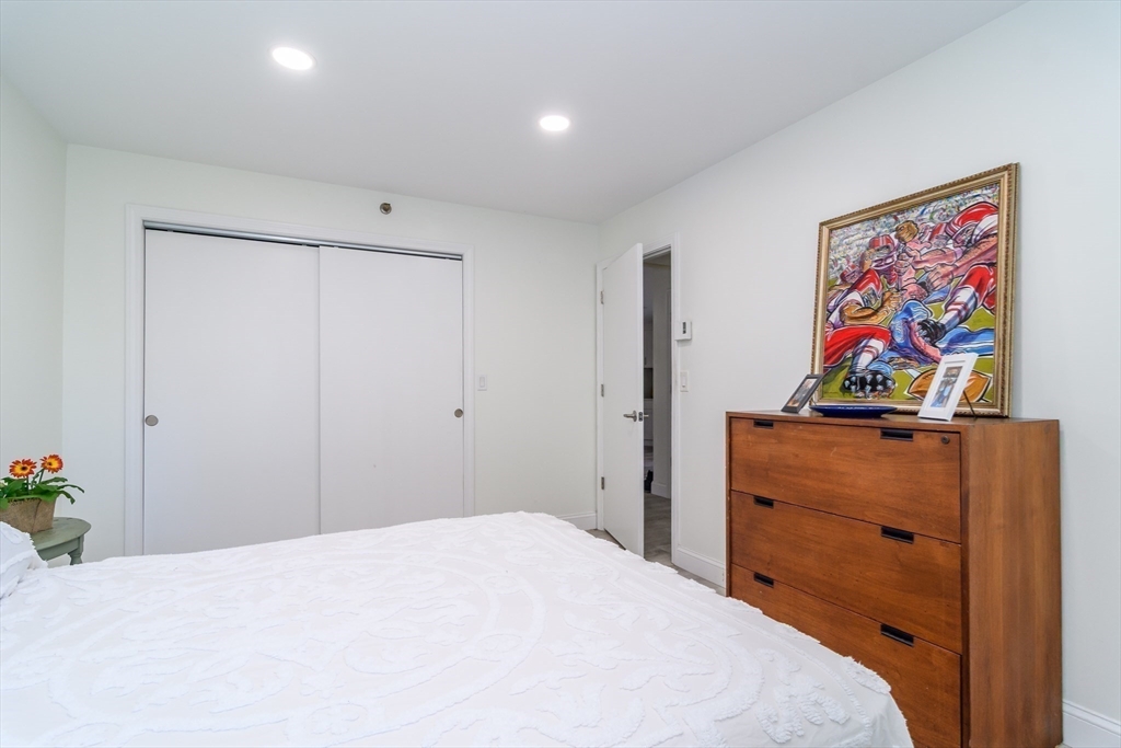 71 Edgeworth Street, Unit 21 Worcester, MA 01605 - Photo 8 of 14 a bedroom with a bed and painting on the wall