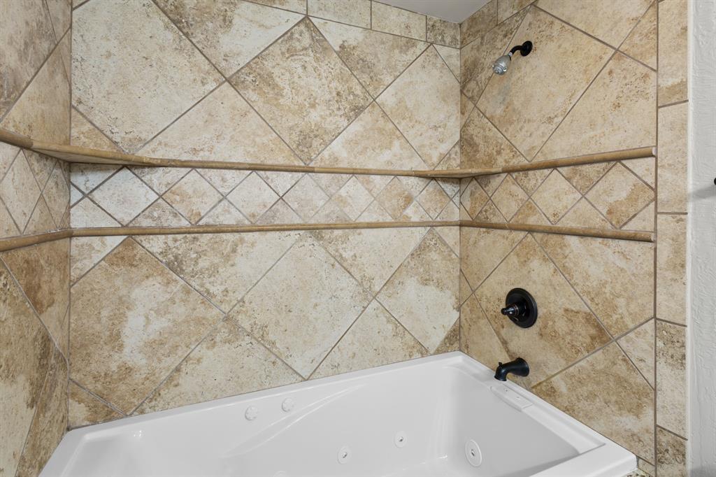 202 Blocker Bridgeport, TX 76426 - Photo 19 of 27 a bathroom with a bathtub and shower