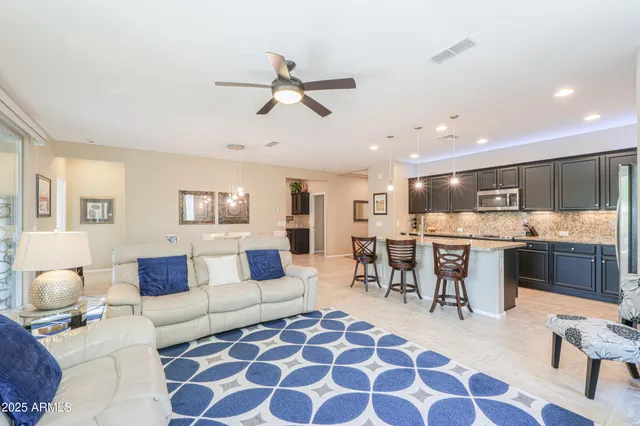 a living room with furniture and kitchen view