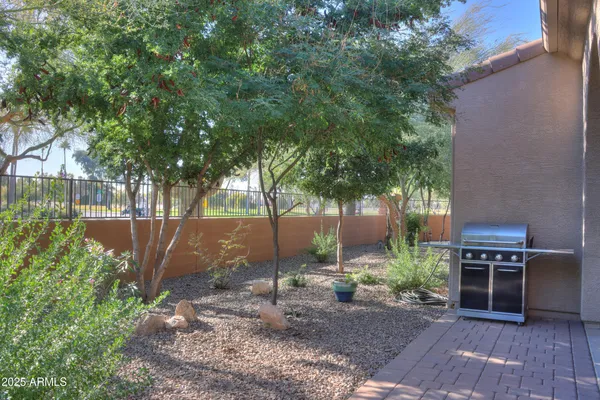 a view of backyard with table and chairs and potted plants