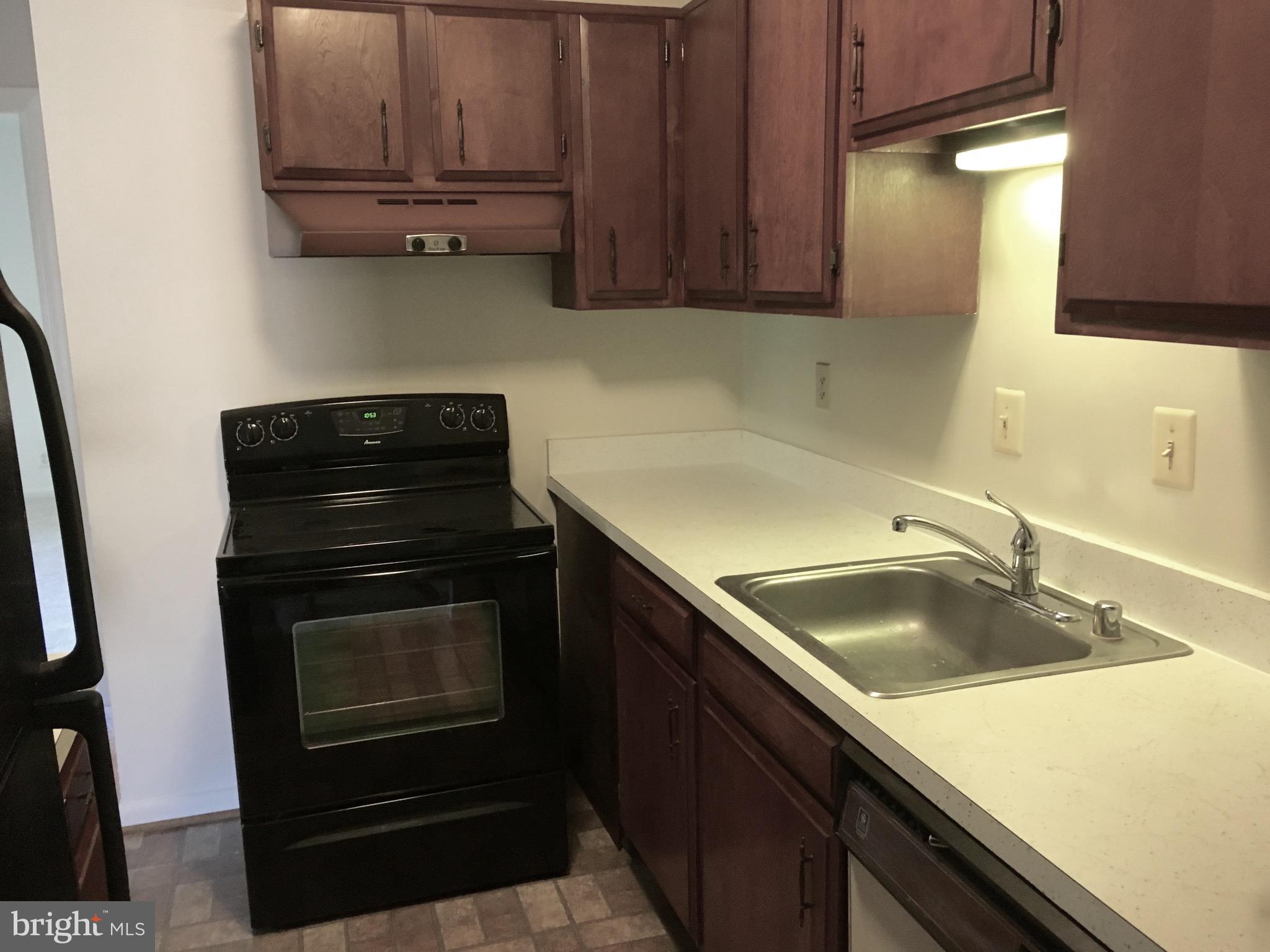 6260 Edsall Road, Unit 401 Alexandria, VA 22312 - Photo 4 of 30 a kitchen with granite countertop a sink stove and cabinets