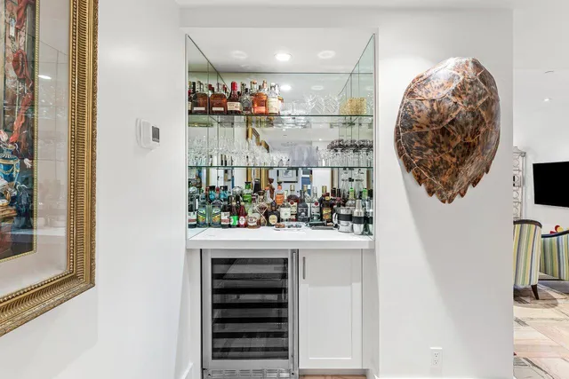 a large white kitchen with stainless steel appliances and a stove