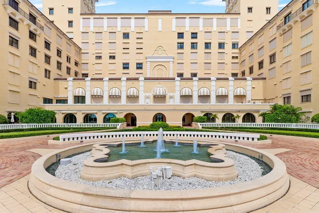 a view of a swimming pool and a lot of trees in the background