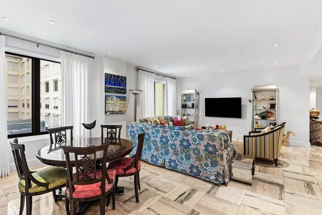 a spacious bedroom with a large bed and large windows