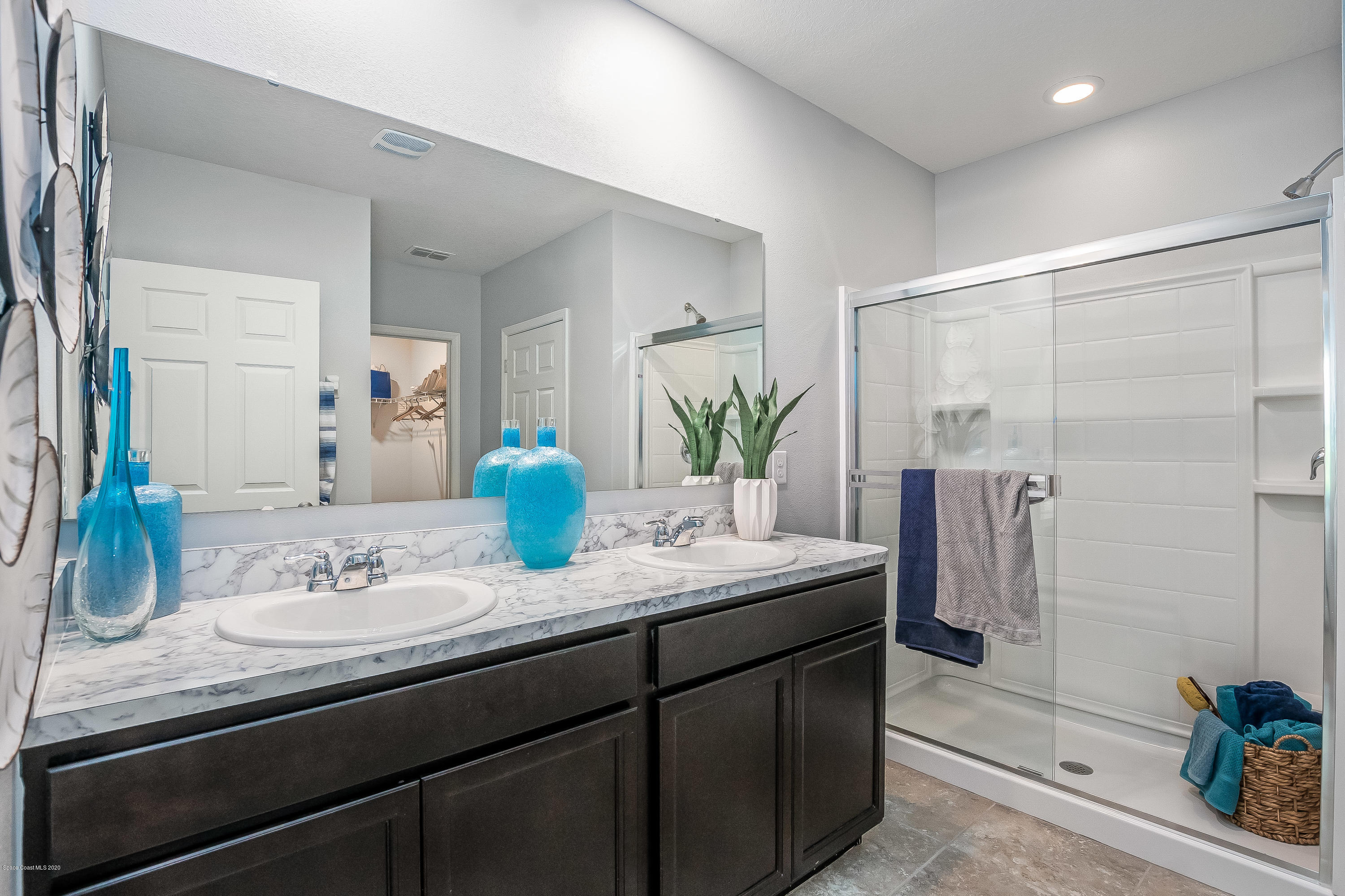 3873 Sandhill Crane Circle Mims, FL 32754 - Photo 14 of 32 a bathroom with a granite countertop sink a shower and a mirror