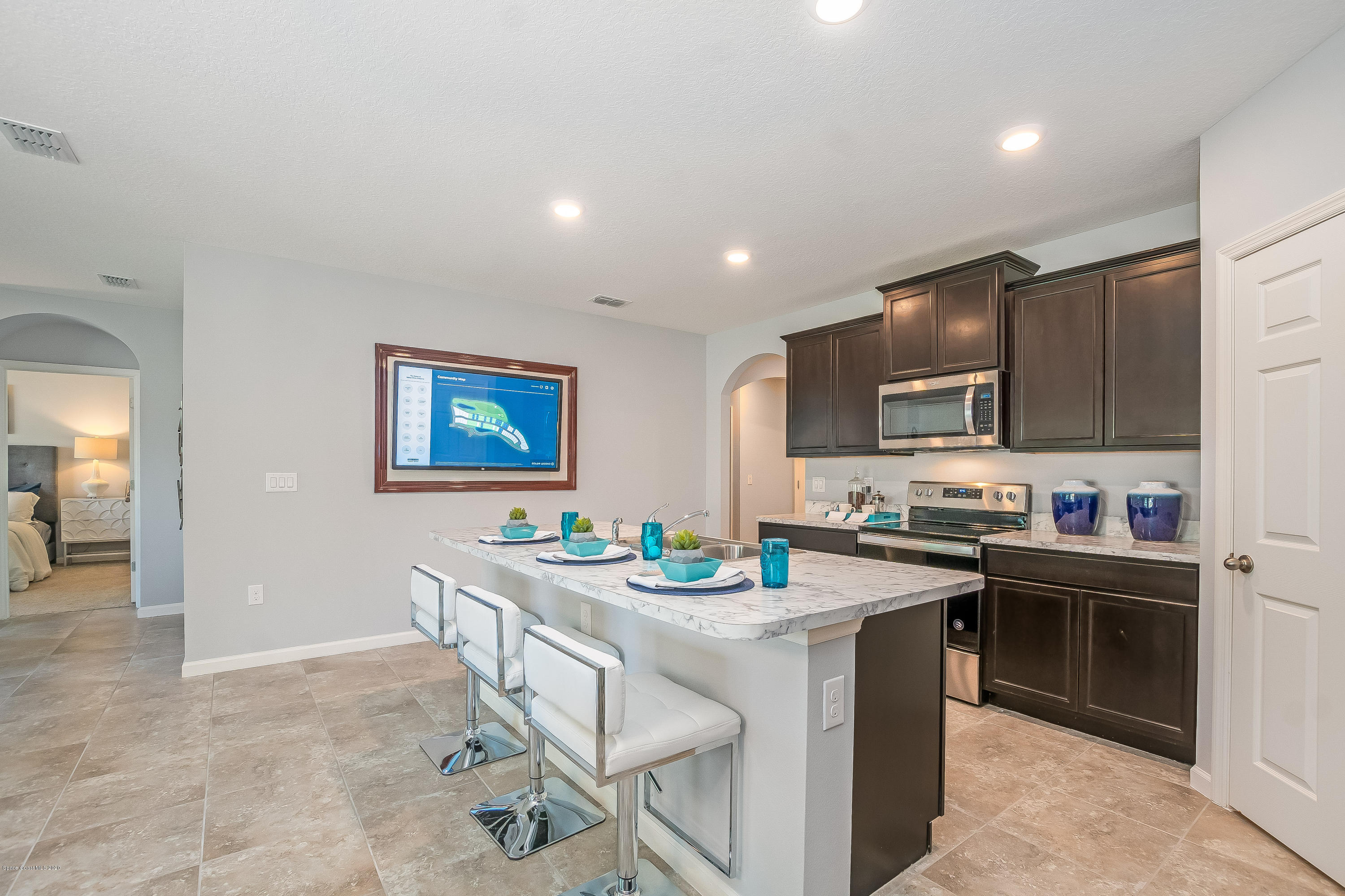 3873 Sandhill Crane Circle Mims, FL 32754 - Photo 5 of 32 a kitchen that has a sink and a stove in it