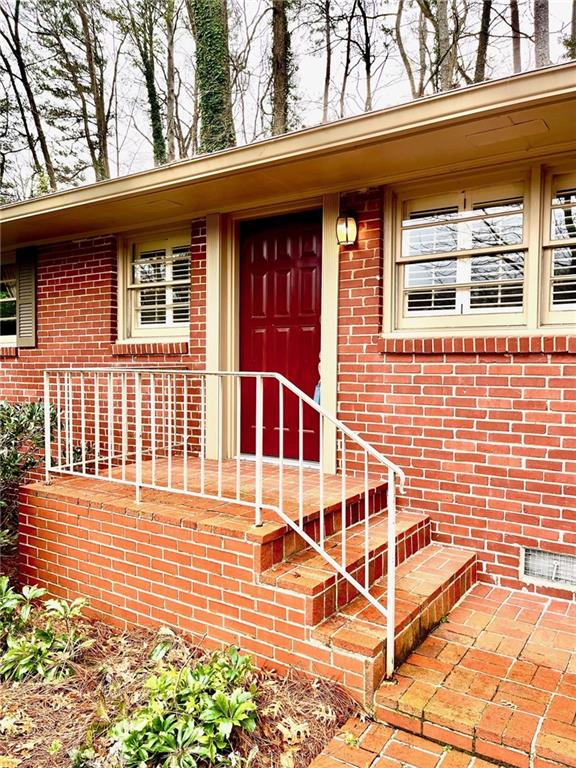a view of a brick house with large windows