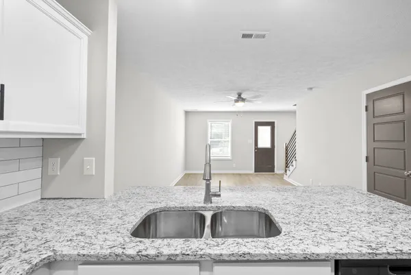 a kitchen with a sink stove and cabinets
