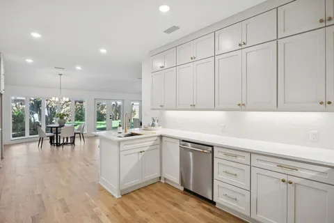a kitchen with sink cabinets and wooden floor