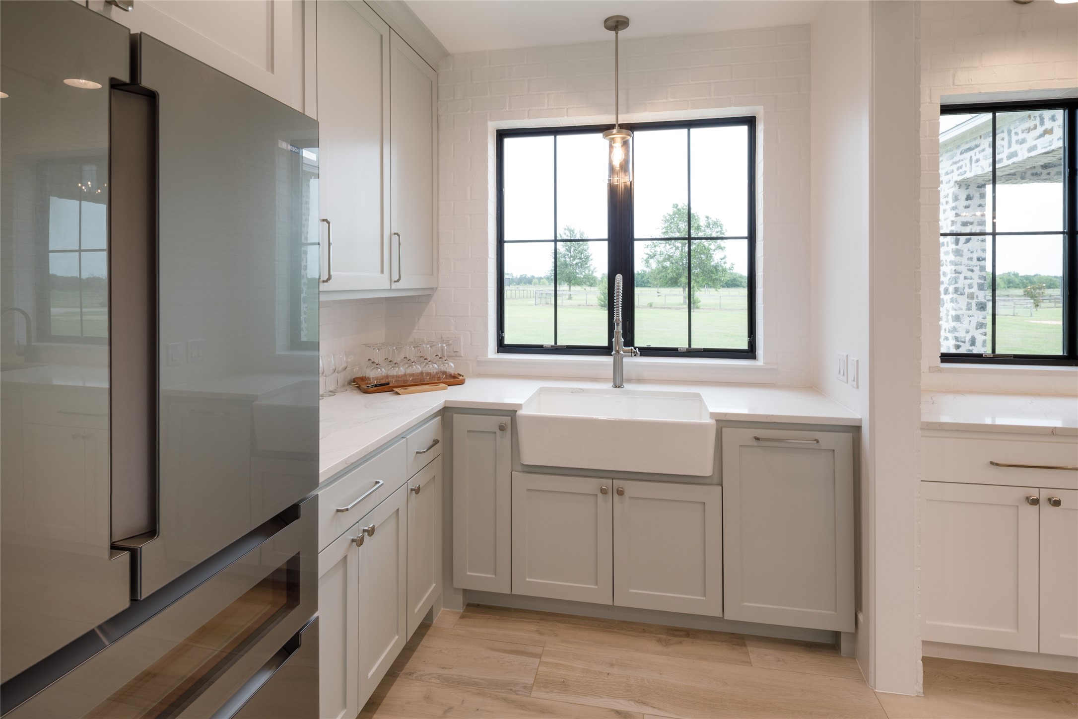 24118 Margerstadt Road Hockley, TX 77447 - Photo 13 of 46 The secondary prep and utility kitchen support the scale of the home with integrated storage, oversized workspace, and additional room for entertaining support behind the scenes. Positioned just off the main kitchen, the layout allows larger gatherings to operate smoothly without interrupting the primary living areas.