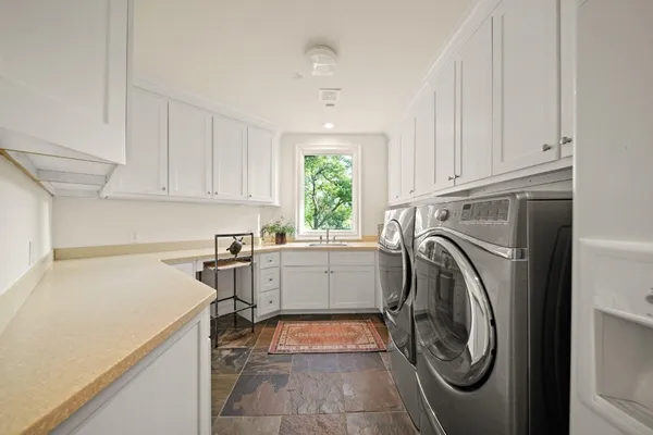 a utility room with sink dryer and washer