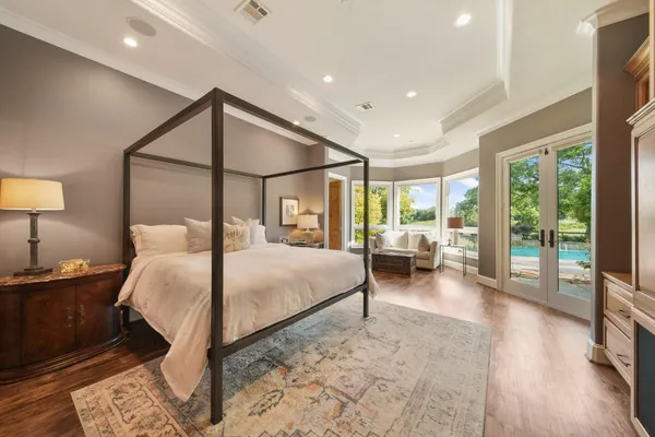 a bedroom with a bed and a large window