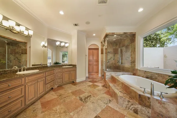 a large spacious bathroom with a large tub shower and sink