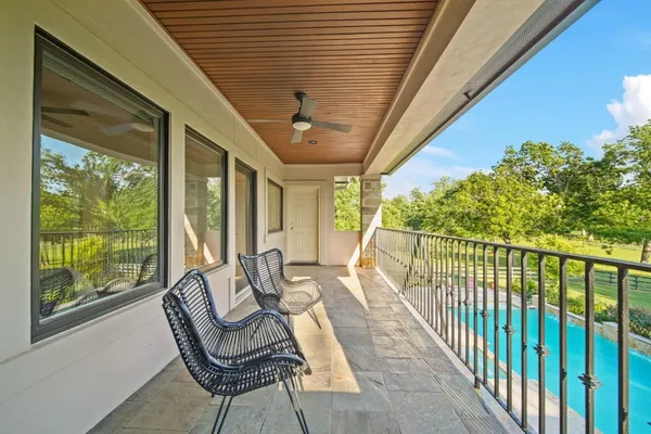 a balcony with furniture and a potted plant