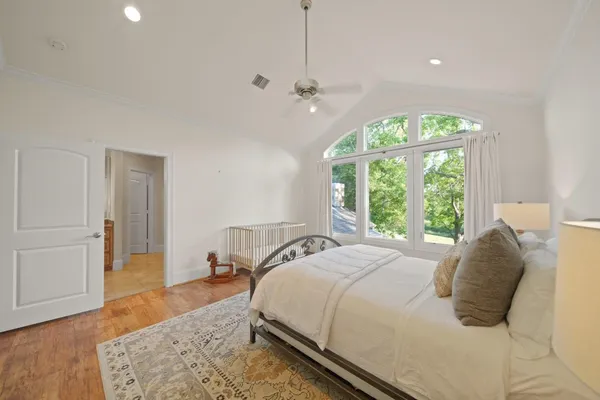 a spacious bedroom with a bed and a large window