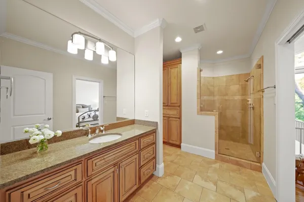 a bathroom with double vanity and a mirror
