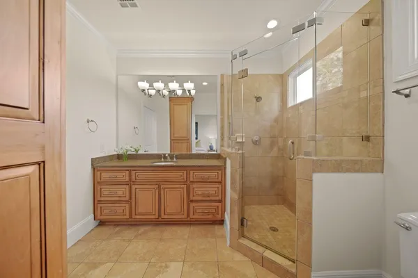 a bathroom with a double vanity sink mirror and shower