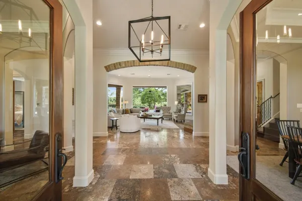 a view of a very nice looking living room with a large window and chandelier