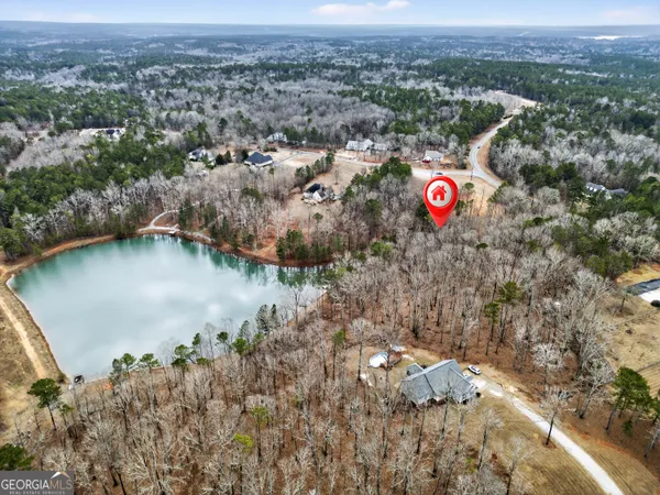 an aerial view of a house with a lake view
