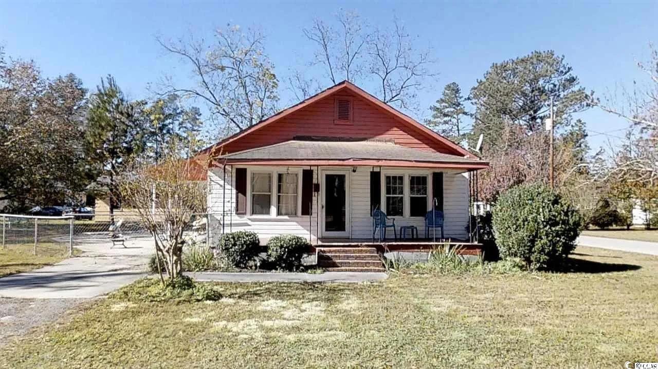 Bungalow-style home with covered porch and a front lawn
