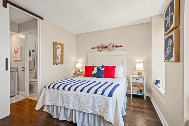 a bedroom with a bed and a painting on the wall