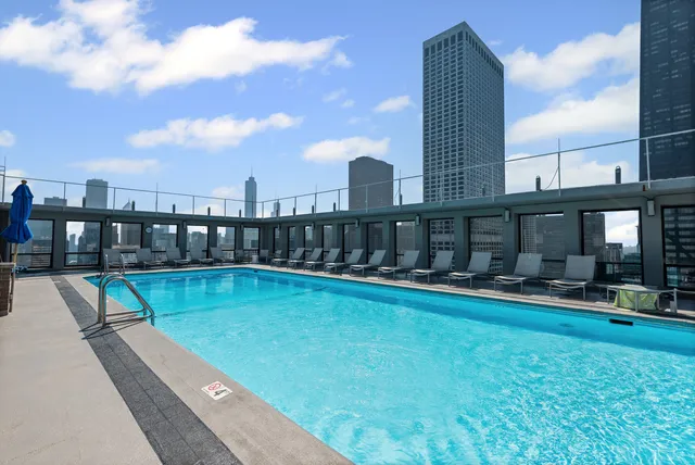 a view of swimming pool with a garden and trees