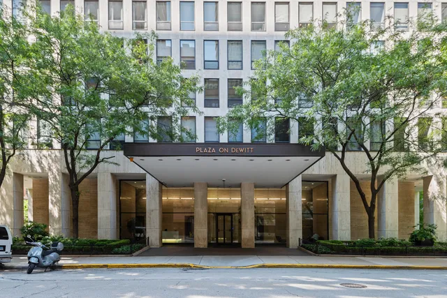 a front view of a building and trees
