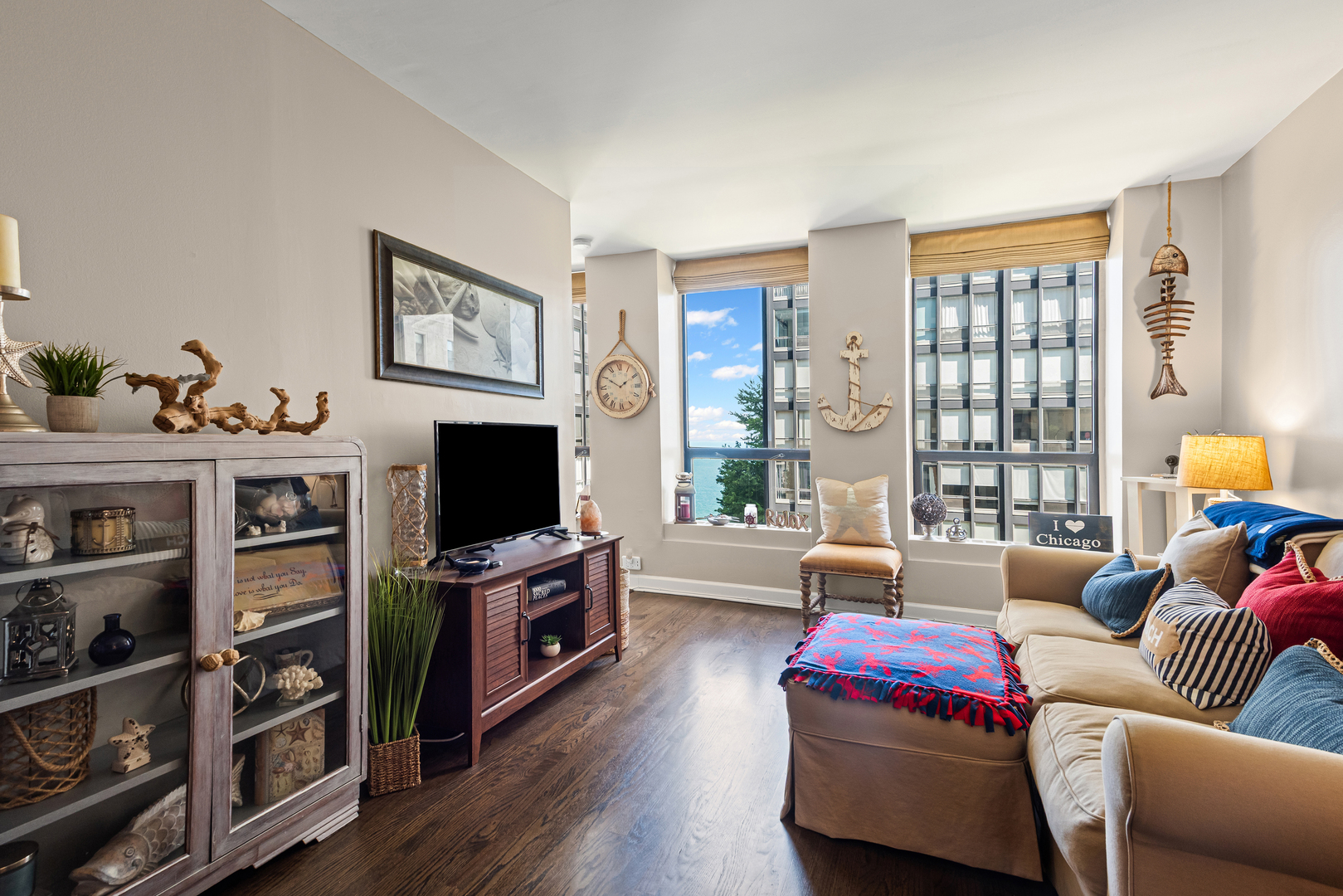 260 East Chestnut Street, Unit 611 Chicago, IL 60611 - Photo 8 of 20 a living room with furniture and a flat screen tv