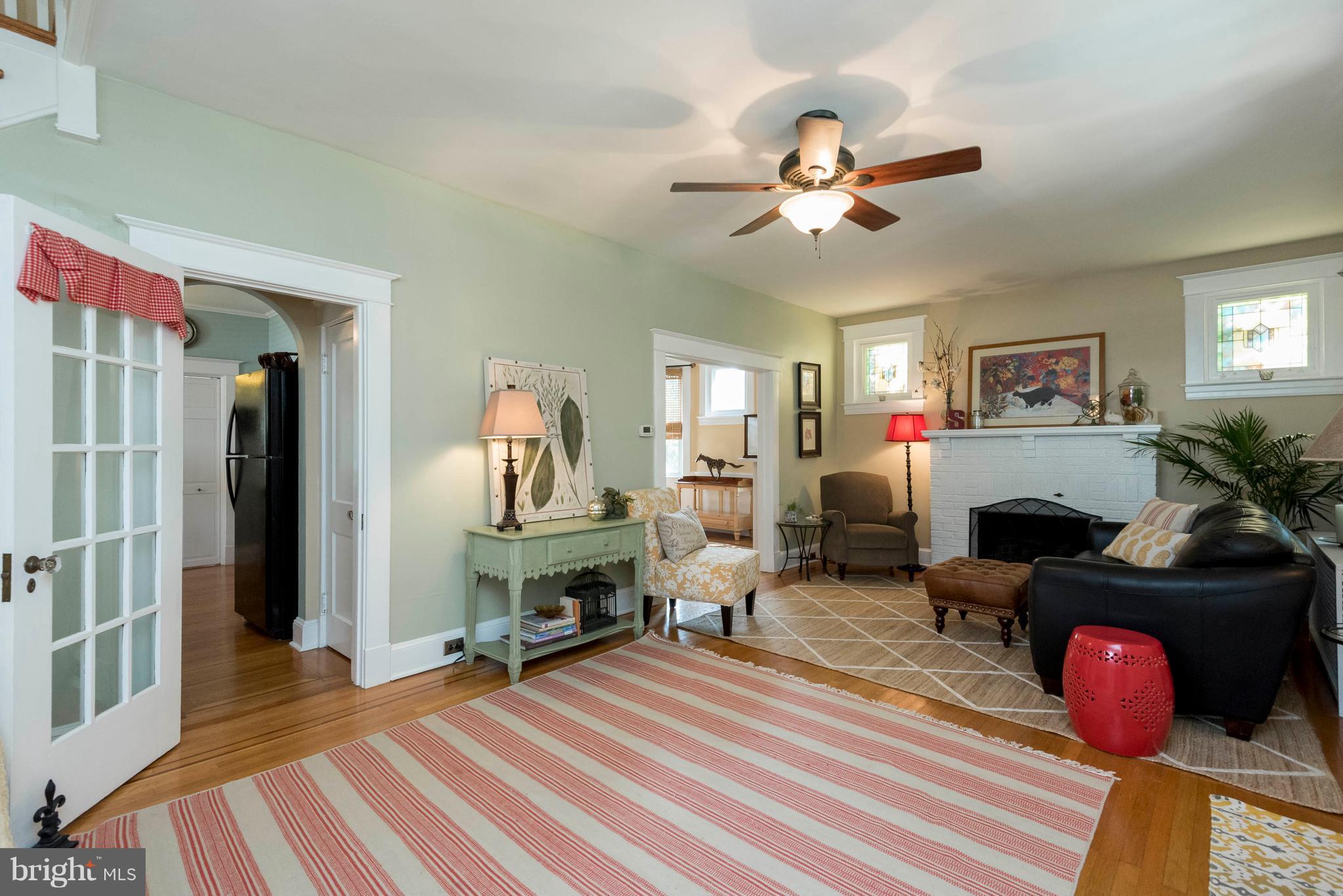 3 Mallow Hill Road Baltimore, MD 21229 - Photo 3 of 30 a living room with furniture a chandelier and a fireplace