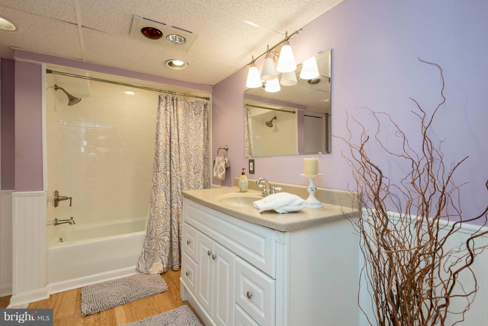 3 Mallow Hill Road Baltimore, MD 21229 - Photo 22 of 30 a bathroom with a sink vanity granite tub shower and a mirror