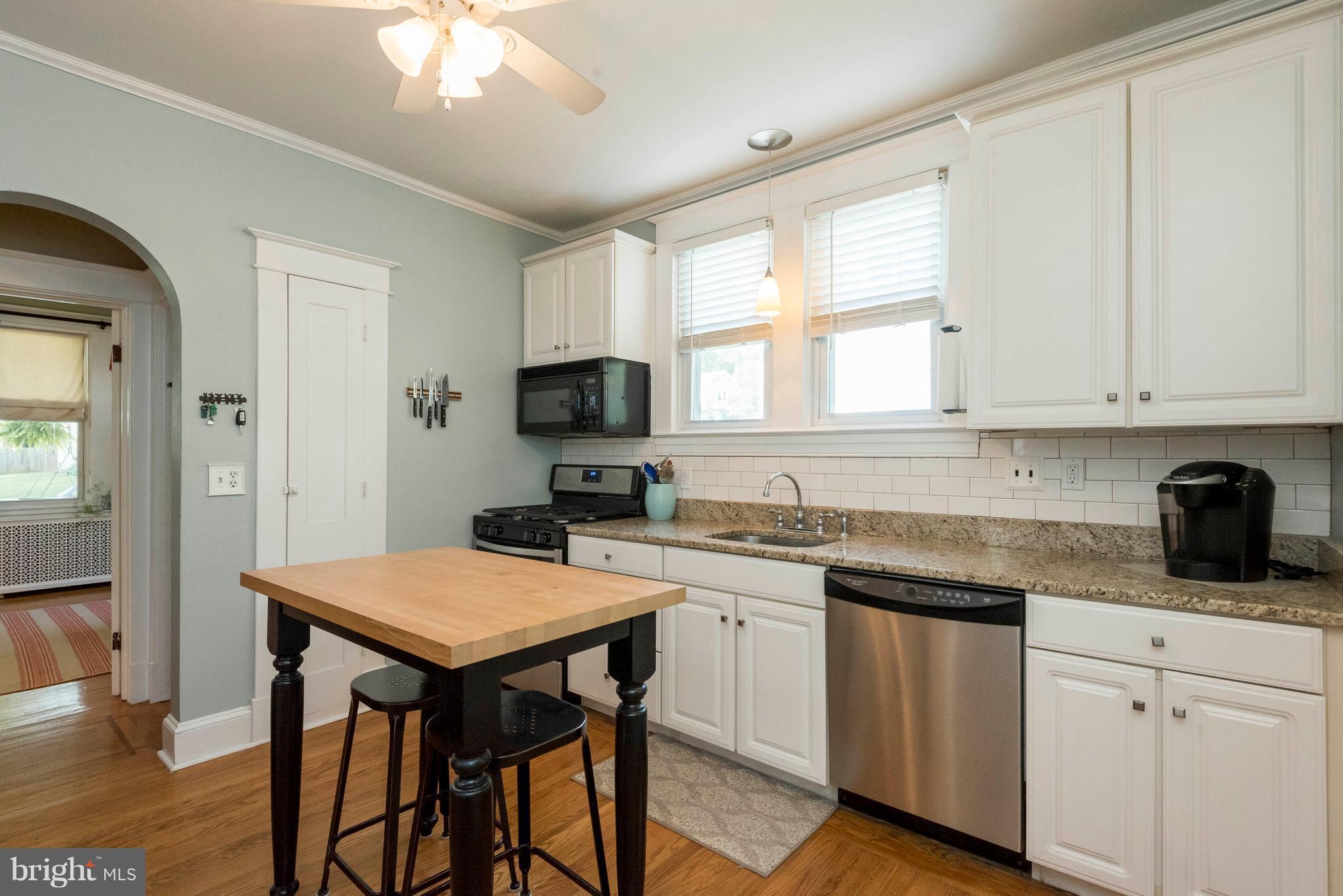 3 Mallow Hill Road Baltimore, MD 21229 - Photo 6 of 30 a kitchen with a table chairs sink and cabinets