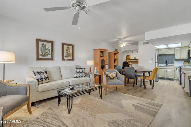 a living room with furniture and a lamp