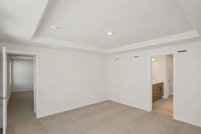 a large white kitchen with stainless steel appliances