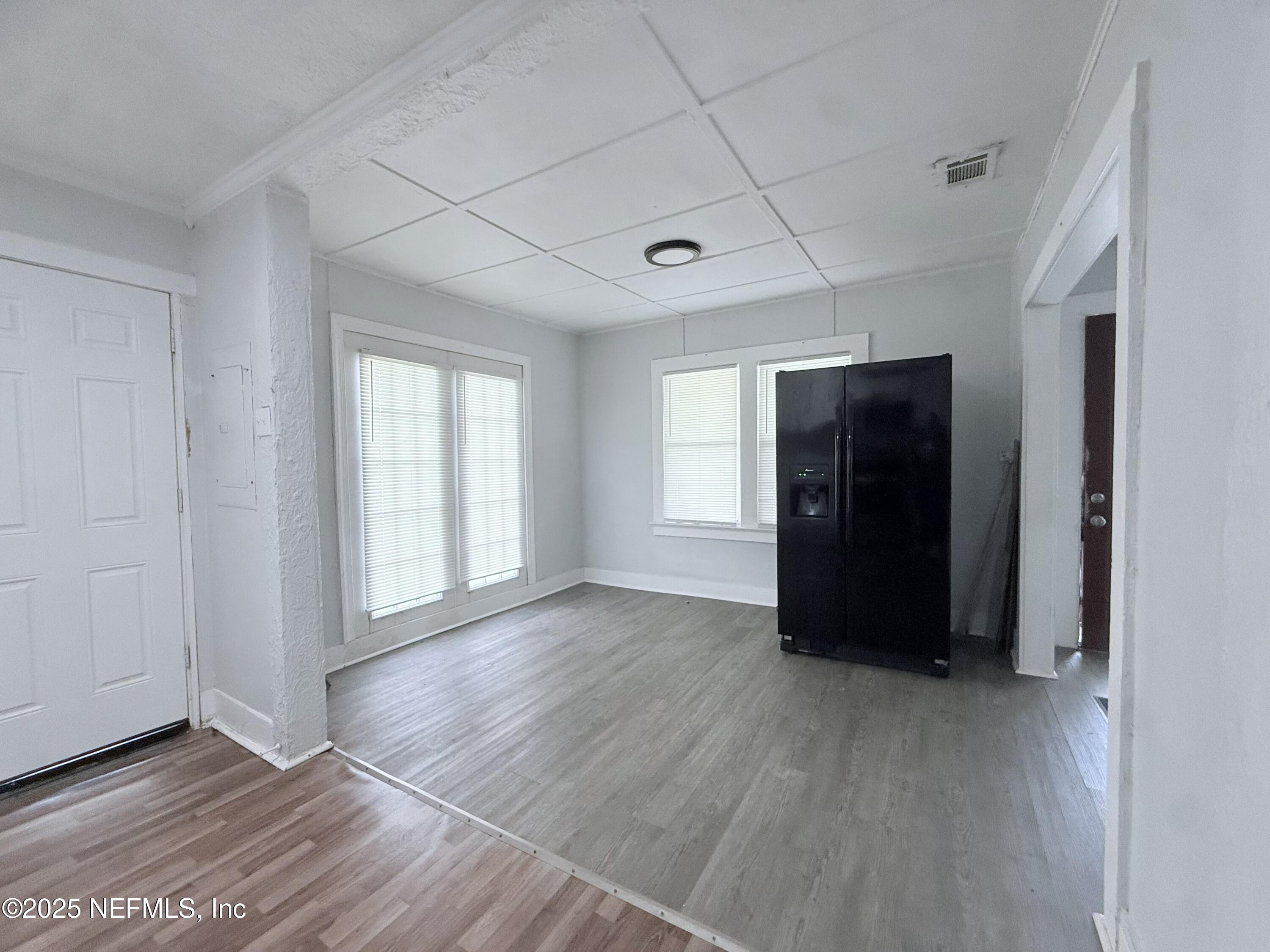 10728 Old Kings Road Jacksonville, FL 32219 - Photo 11 of 27 a view of an empty room with wooden floor and a window