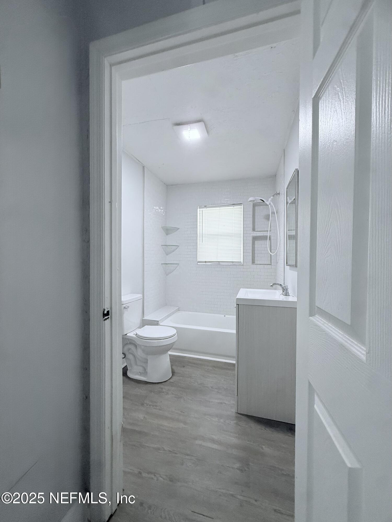 10728 Old Kings Road Jacksonville, FL 32219 - Photo 13 of 27 a bathroom with a toilet a sink and bathtub