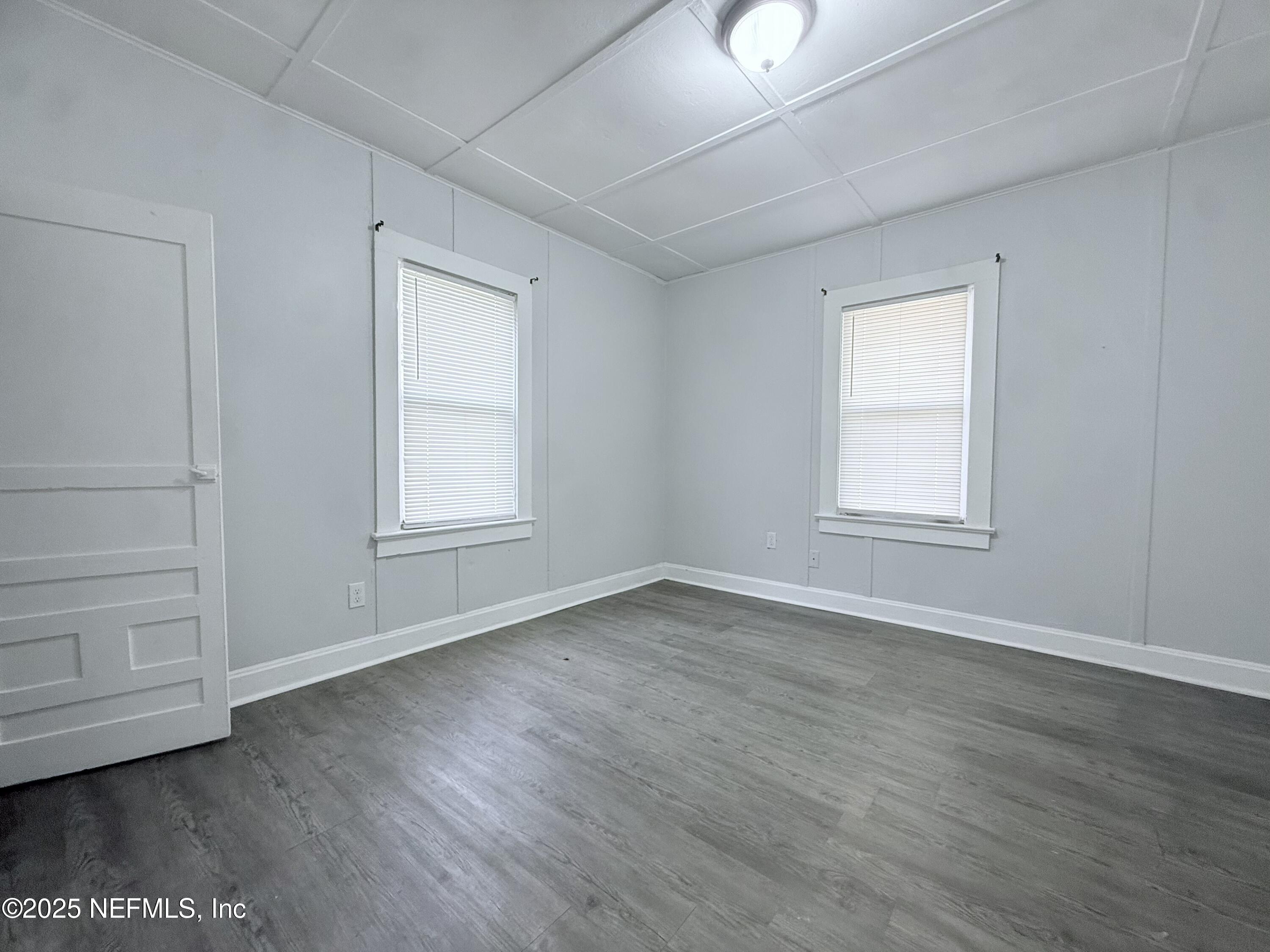 10728 Old Kings Road Jacksonville, FL 32219 - Photo 14 of 27 an empty room with wooden floor and window