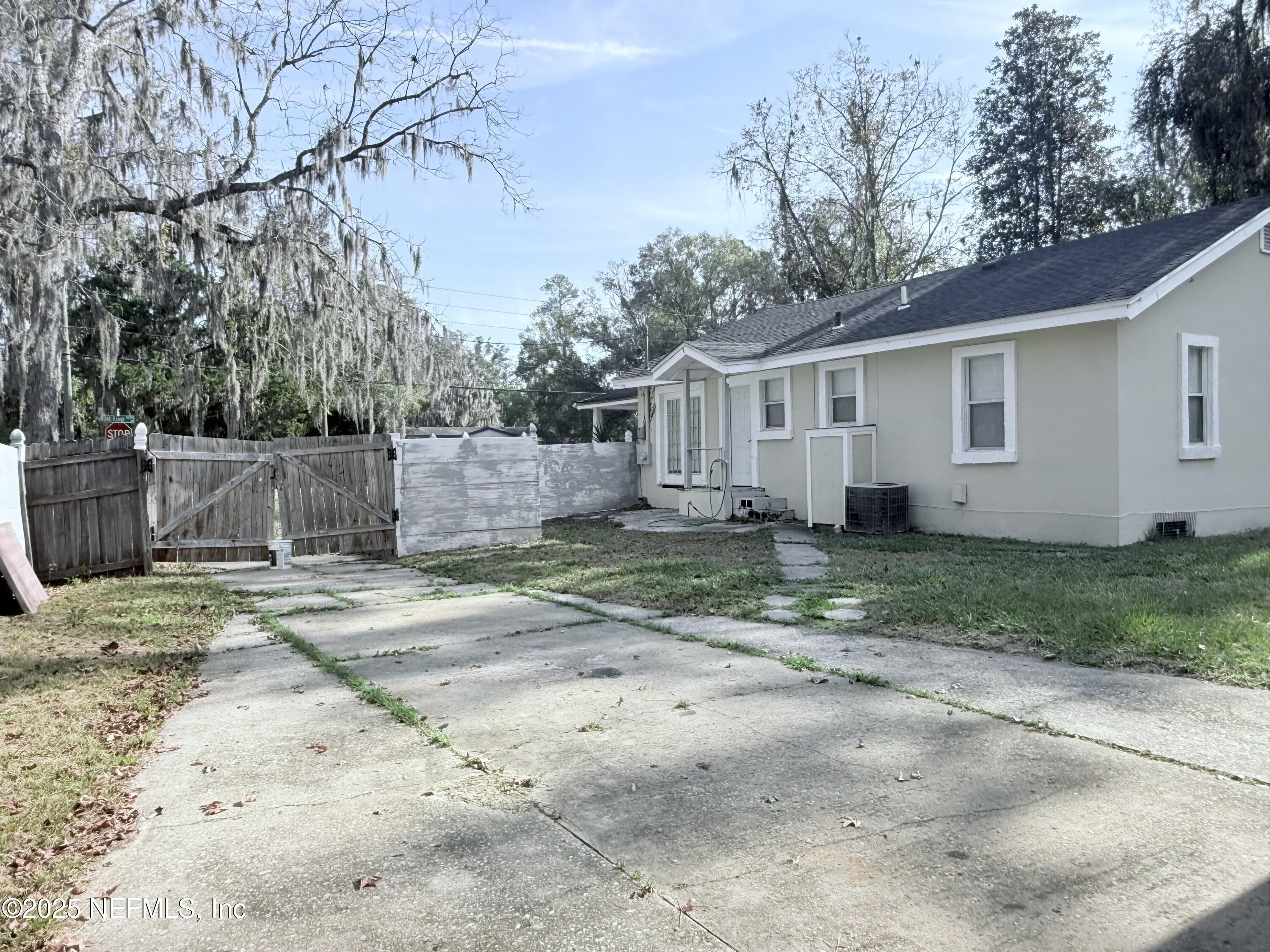 10728 Old Kings Road Jacksonville, FL 32219 - Photo 27 of 27 a view of a yard with a house and a tree