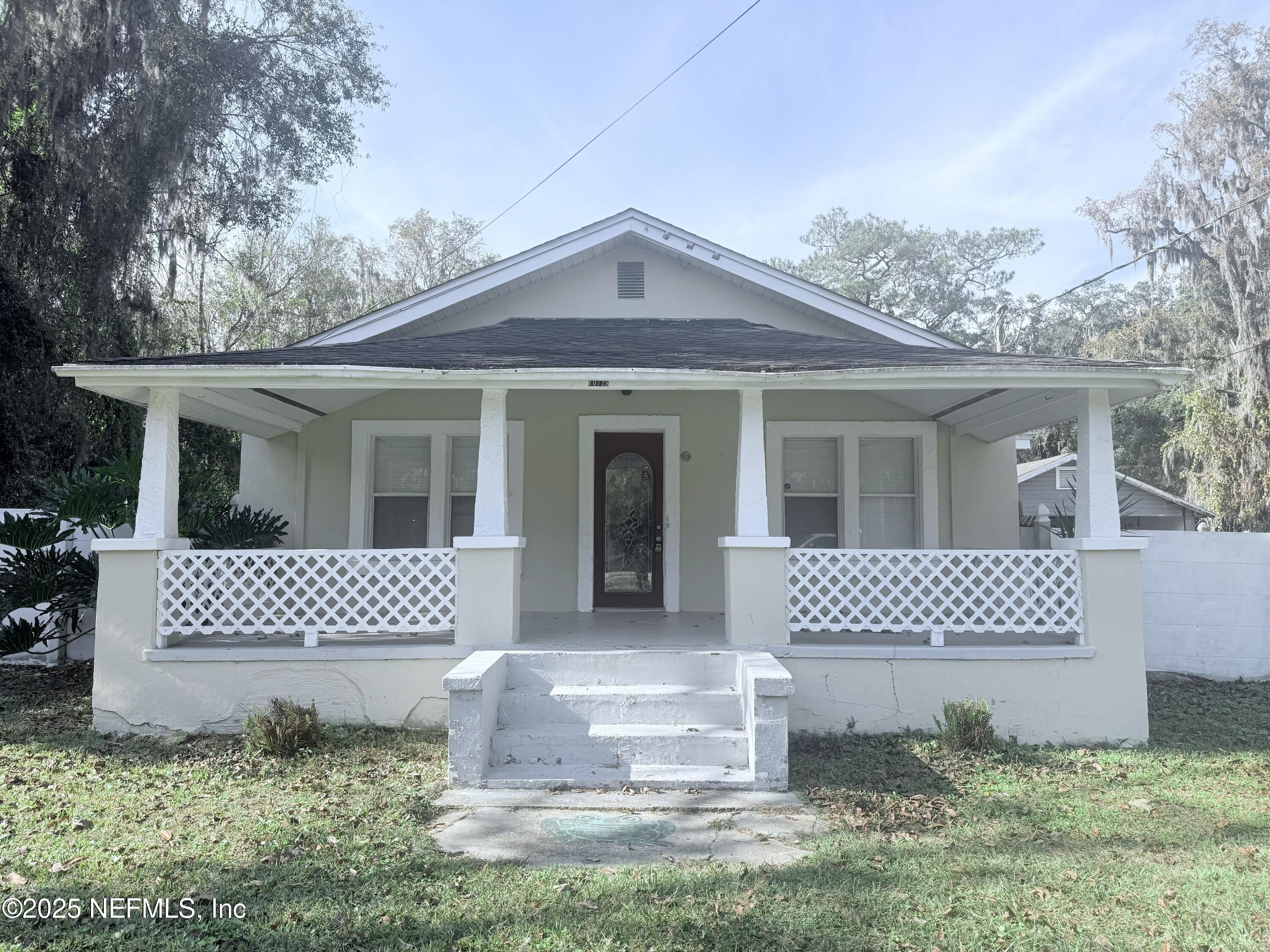 10728 Old Kings Road Jacksonville, FL 32219 - Photo 4 of 27 a front view of a white house with a garden
