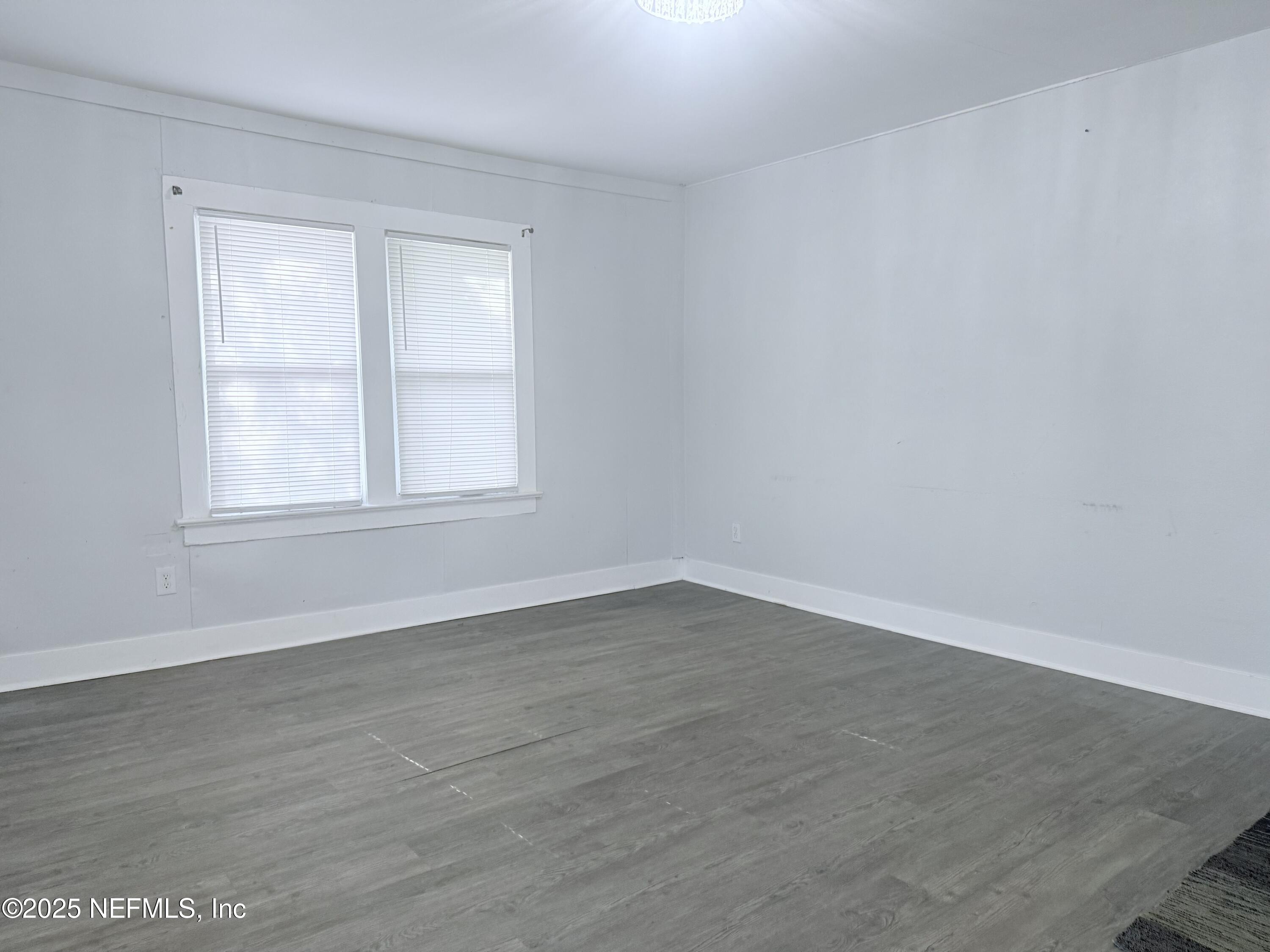 10728 Old Kings Road Jacksonville, FL 32219 - Photo 7 of 27 wooden floor in an empty room with a window