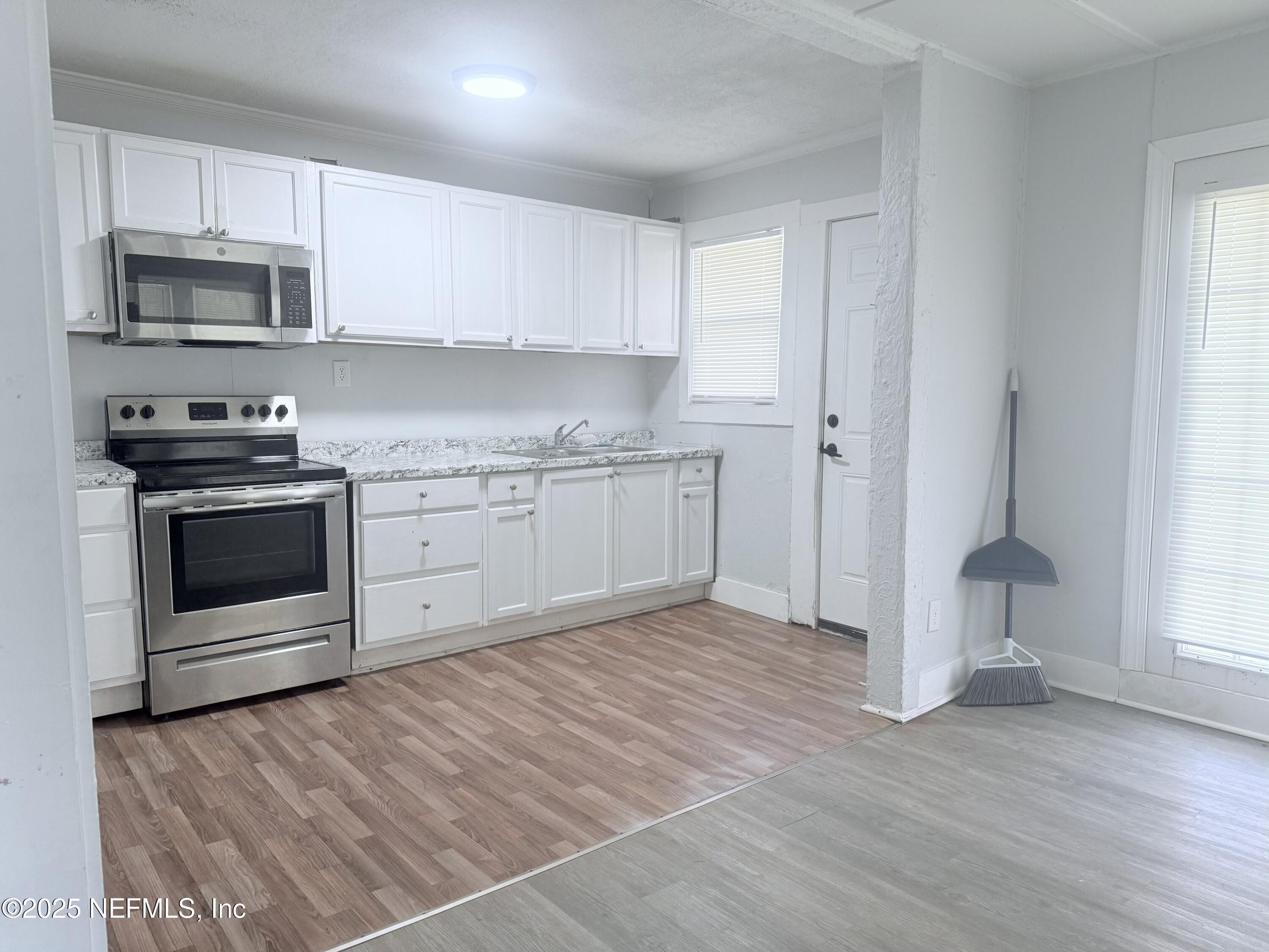 10728 Old Kings Road Jacksonville, FL 32219 - Photo 9 of 27 a kitchen with stainless steel appliances granite countertop a stove a sink and a microwave