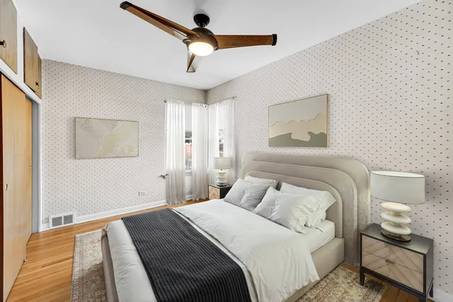 a bedroom with a bed and a painting on the wall